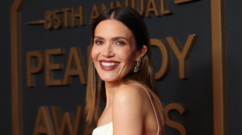 Mandy Moore wears a white dress with thin straps and her brown hair down at the 85th Annual Peabody Awards in Beverly Hills, California in June 2025.