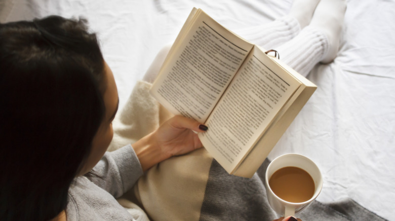 Woman reading a paperback book