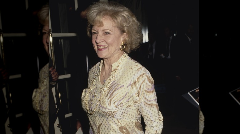 American actress and comedian Betty White, wearing yellow print pattern dress, smiling as she attends 5th Annual Genesis Awards, presented by the Humane Society of the United States (HSUS) for raising public awareness of animal rights issues, held at the Beverly Wilshire Hotel in Beverly Hills, California, 3rd February 1991
