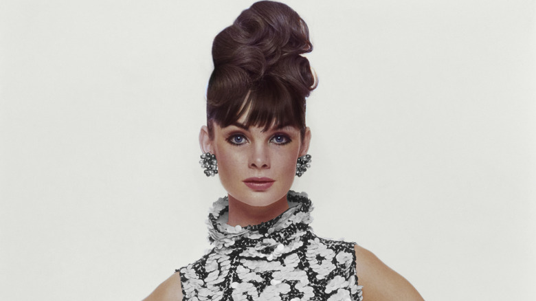Jean Shrimpton poses wearing a black-and-white dress and a high bun