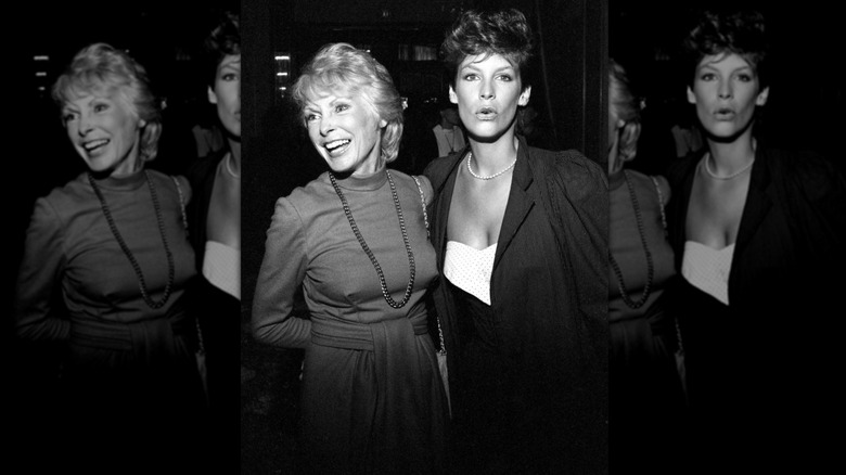 Janet Leigh posing in a mock-turtleneck dress with Jamie Lee Curtis wearing a white top with a dark jacket in March 1983.