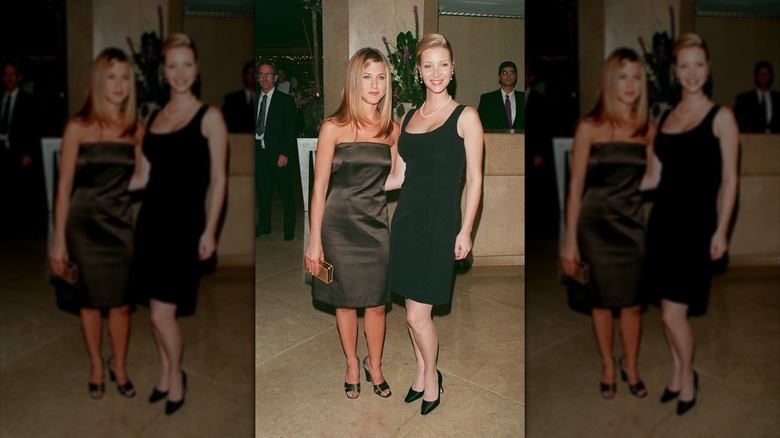 Lisa Kudrow wearing a little black dress posing next to Jennifer Aniston.