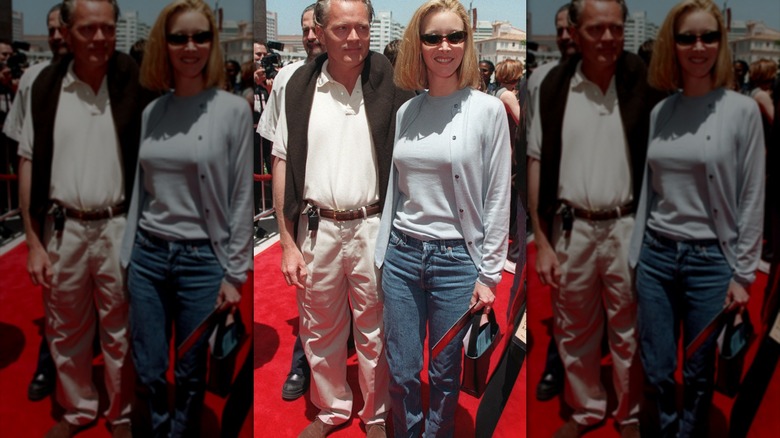Lisa Kudrow posing at a red carpet event in denim and a cardigan.