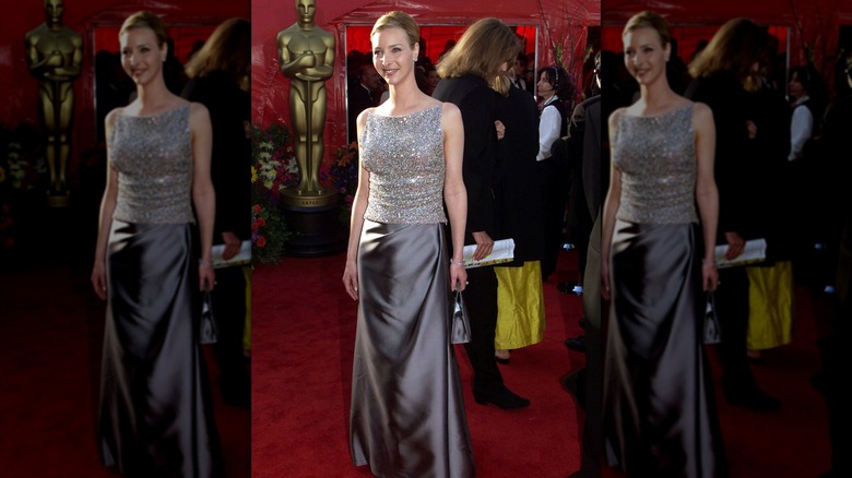 Lisa Kudrow posing at a red carpet event in a sequined and duchesse satin dress.