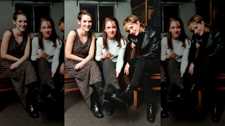 Winona Ryder, Liz Phair, and Rosanna Arquette photographed sitting next to each other.
