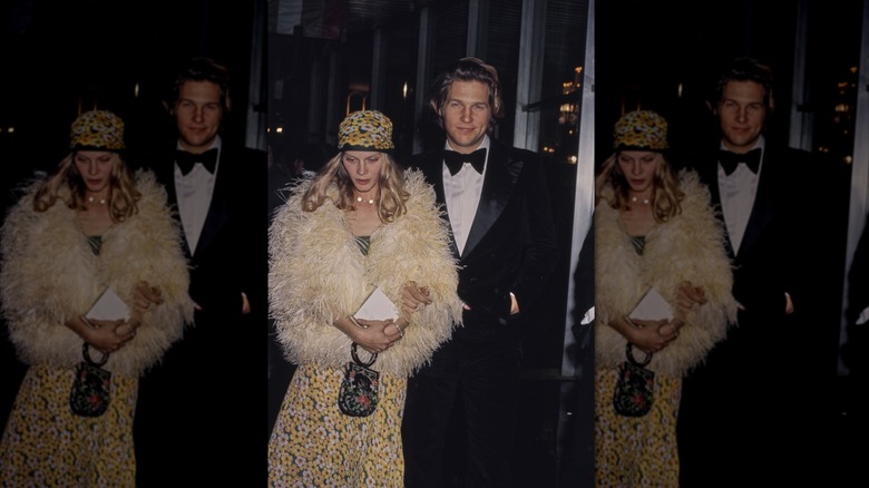 Jeff Bridges in a black tux and his wife Susan Geston wearing a floral hat and dress with a feathery coat pictured at the 1975 Academy Awards.