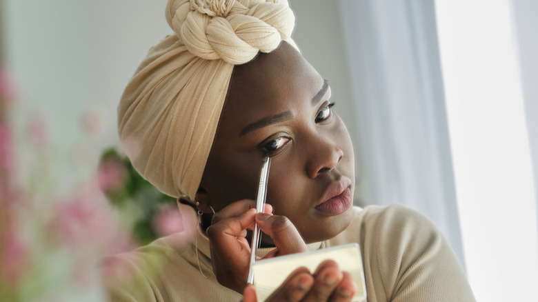 Woman applying eye makeup