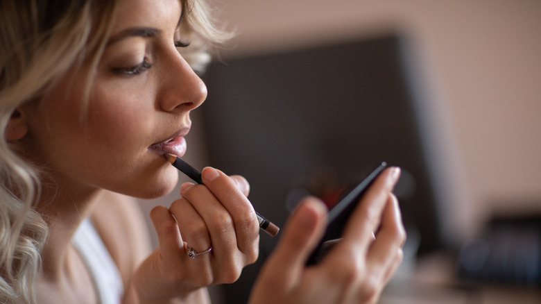 woman applying lip liner