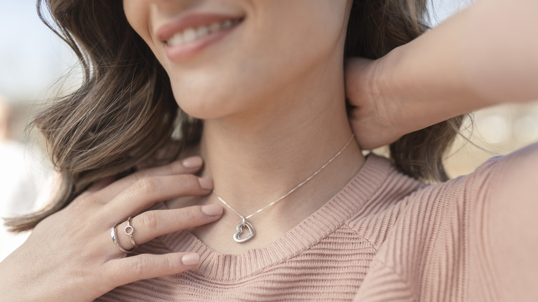 woman touching necklace