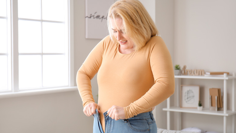 woman struggling with pants