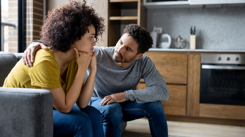A couple talking on the couch