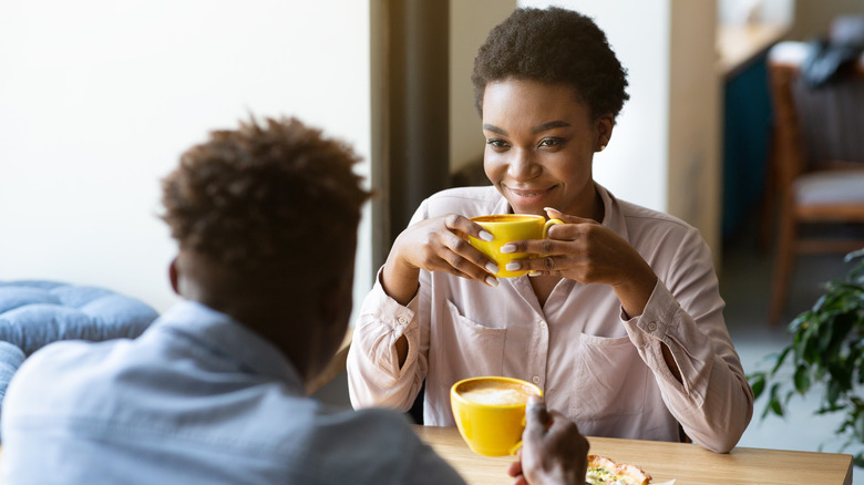 Woman smiling at man