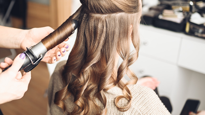 woman getting hair styled 