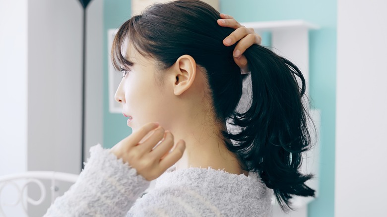 Woman putting her hair up