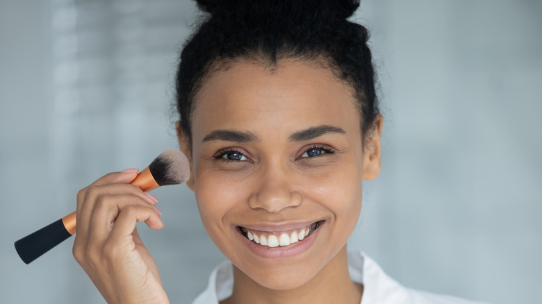 Woman applying makeup 