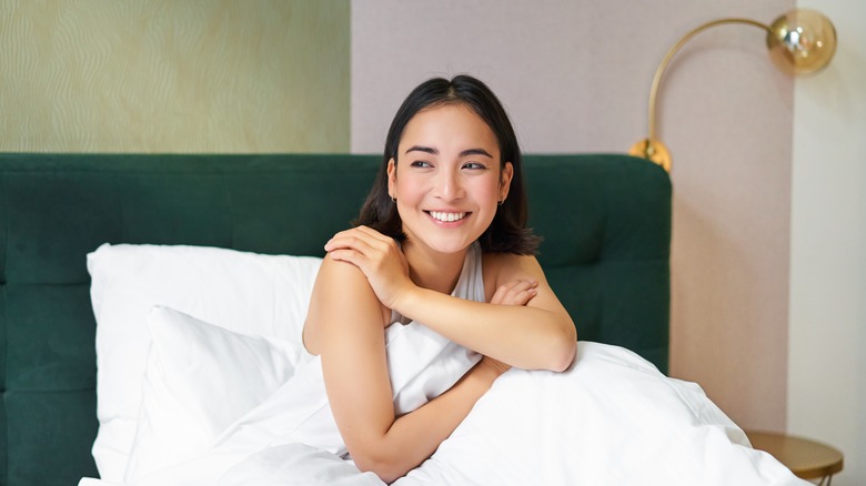 woman smiling in bed
