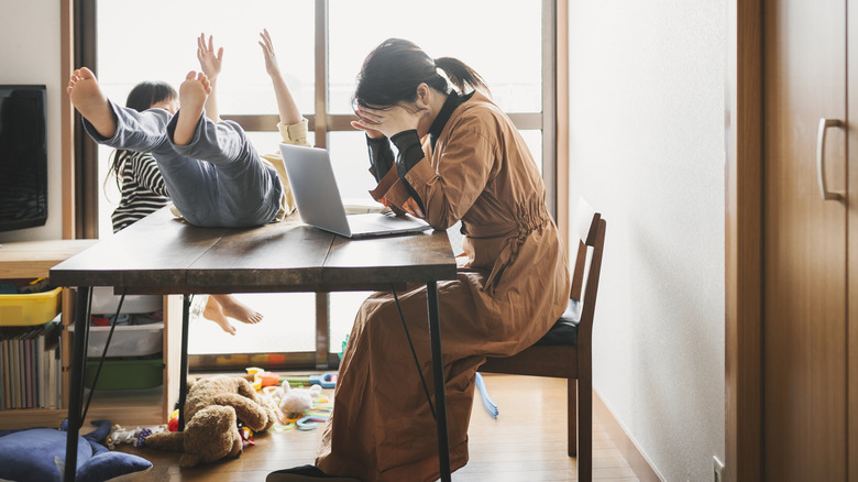 Woman in chaotic kitchen