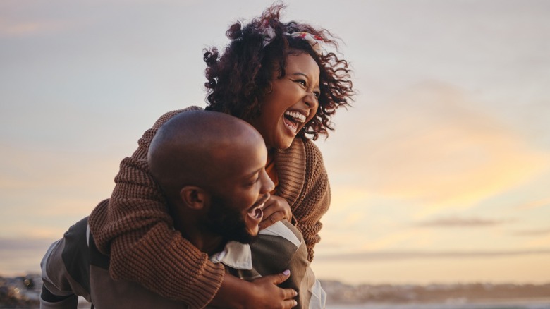 Man giving woman piggyback ride