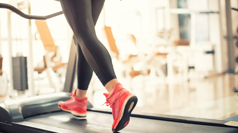 Woman walks on treadmill