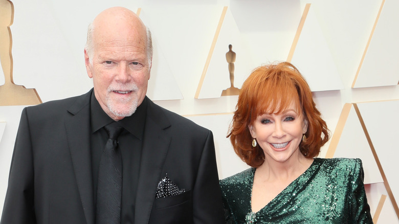 Reba McEntire and Rex Linn posing at the 2022 Academy Awards