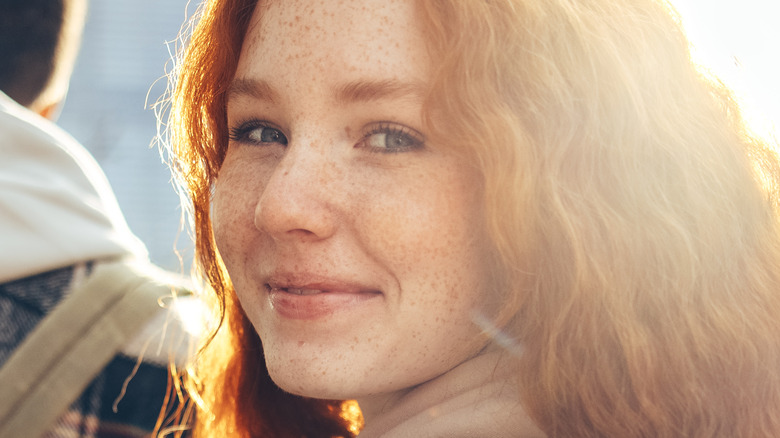 female smiling in sun