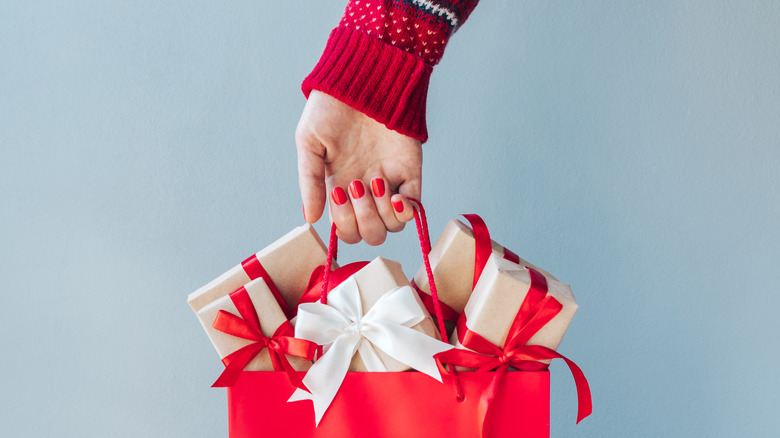 Person holding holiday gifts