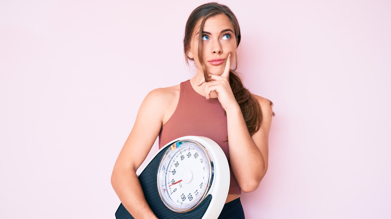 woman holding scale