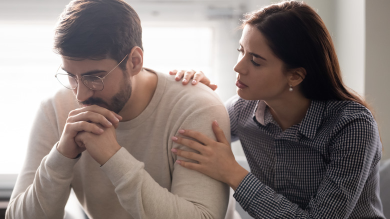 woman comforting upset man