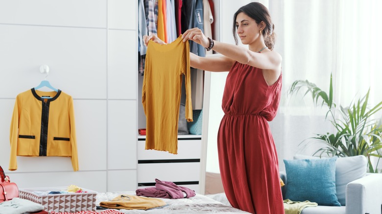 Woman assesses wardrobe 