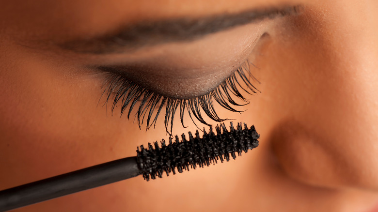 woman applying mascara 