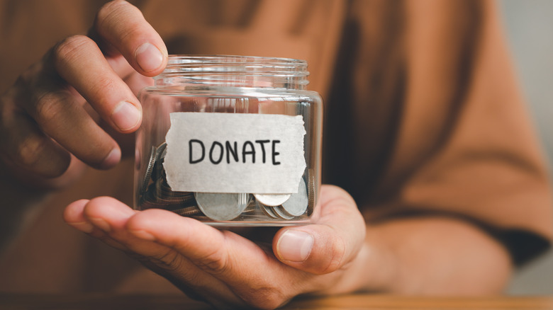 Jar of coins with 'Donate' sign