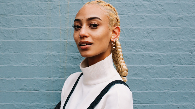 woman with blond hair by wall 