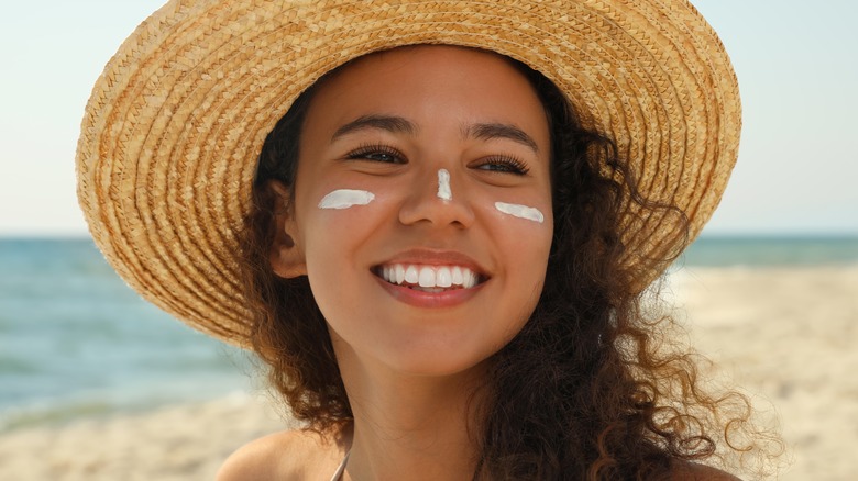 woman wearing sunblock outside