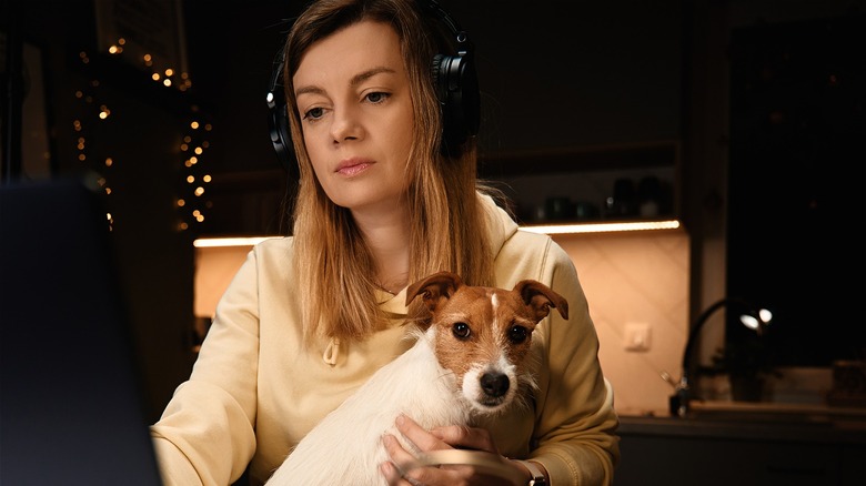 woman at laptop with dog