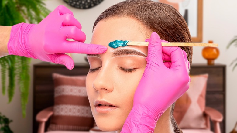 women getting her eyebrows waxed