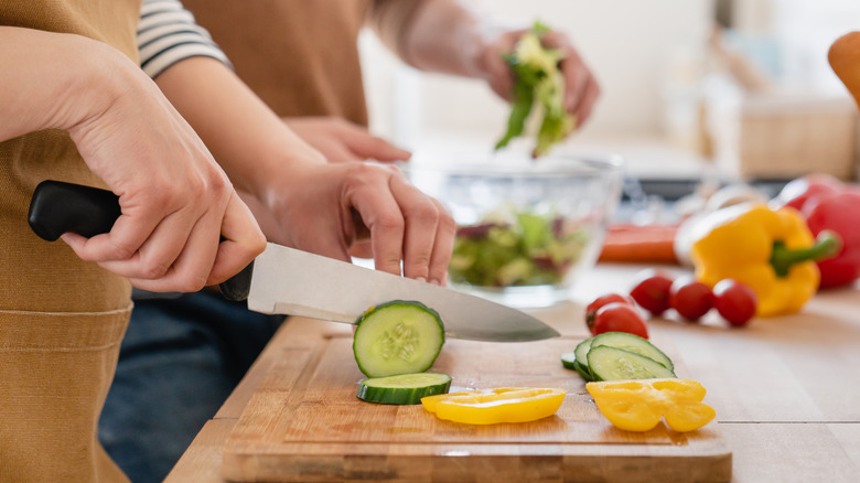 couple slicing veggies