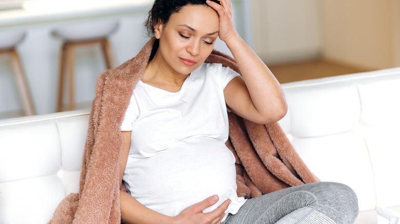 tired pregnant mom on couch