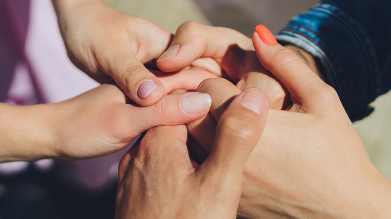 men and women holding hands