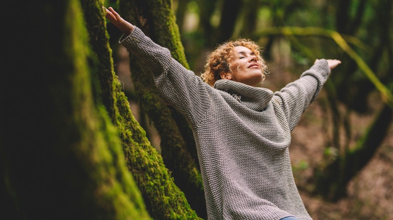 Woman with arms raised 