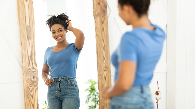 smiling woman looking in mirror