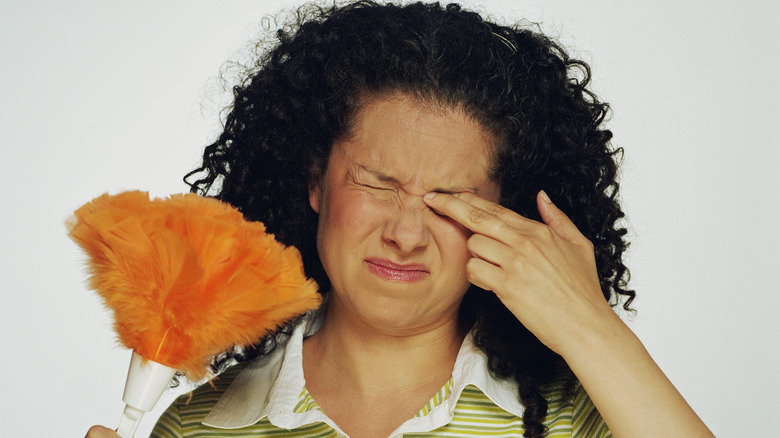 female rubbing her eye