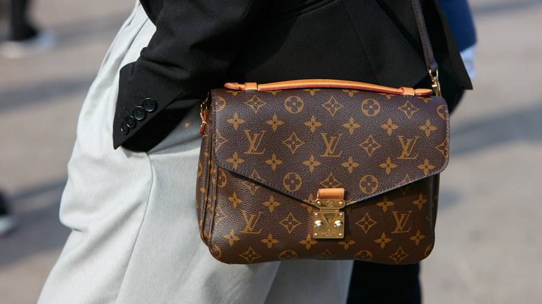 woman with Louis Vuitton monogrammed bag