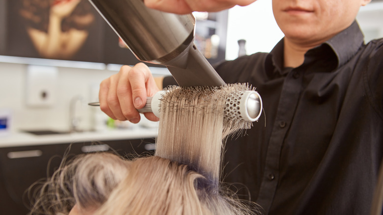Client getting hair blow-dried