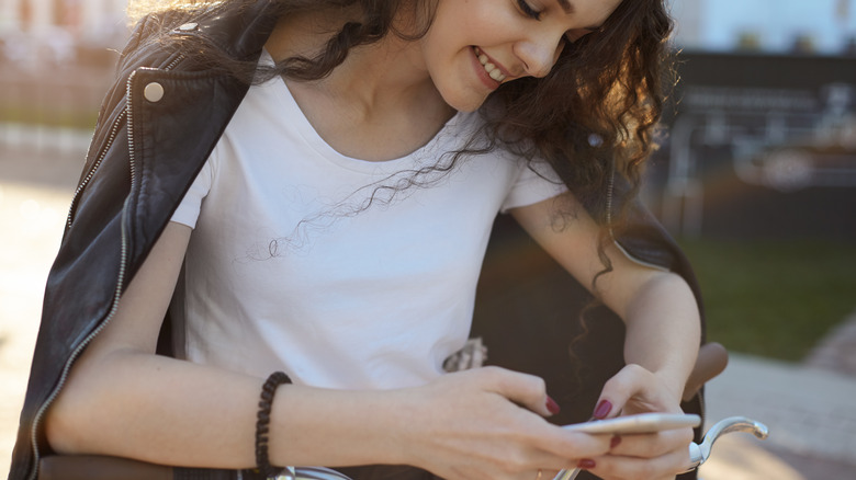 Woman smiling texting