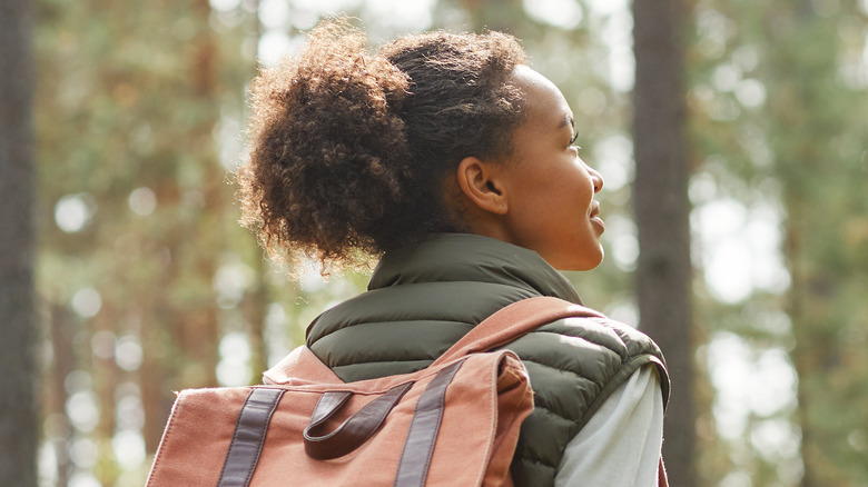 Black woman hiking alone with backpack