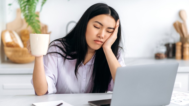 woman sleeping at computer 