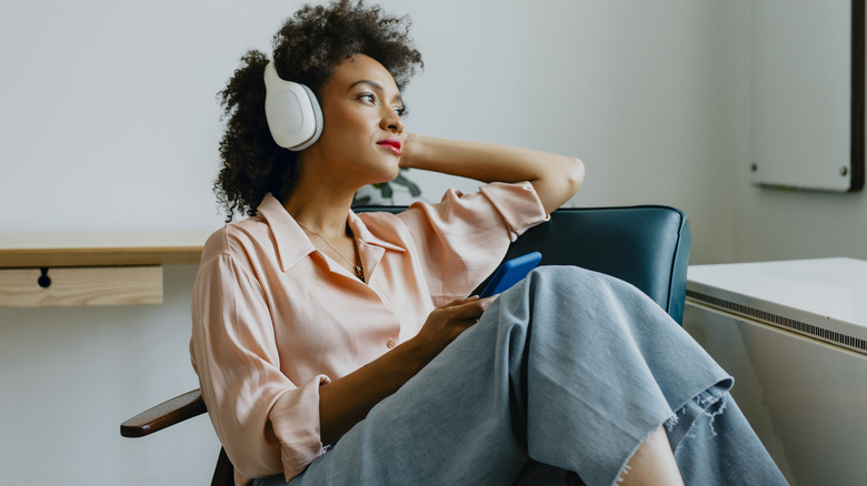 woman wearing button-down and headphones