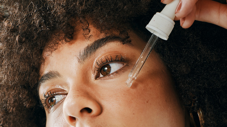 Woman applying serum