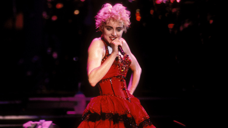 Madonna wearing a red corset dress