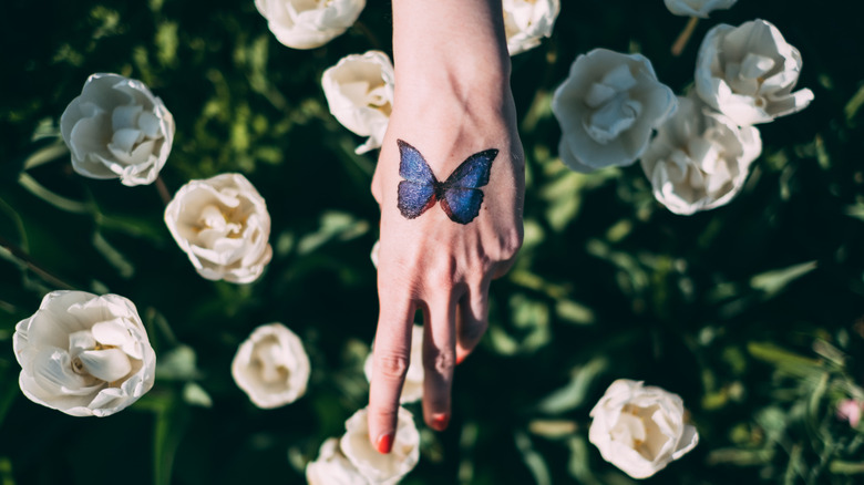 hand with a butterfly tattoo